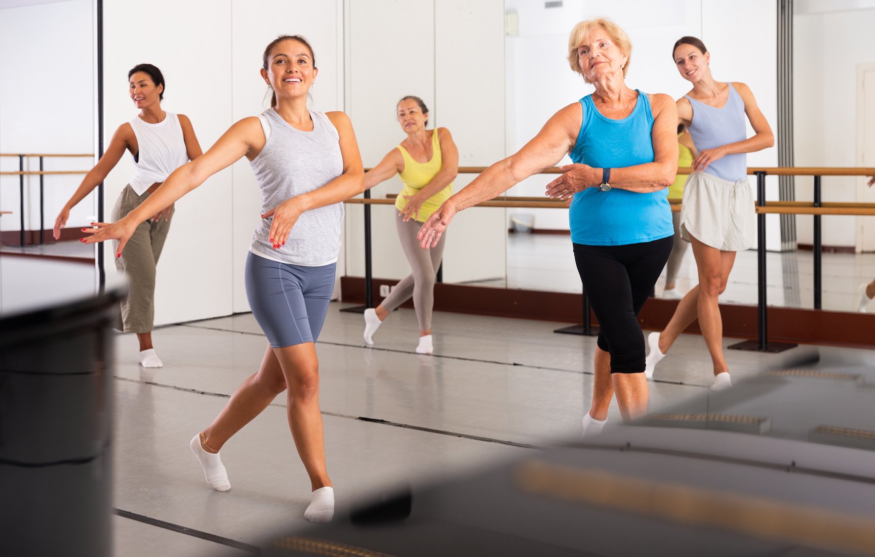 Women performing modern dance in fitness studio