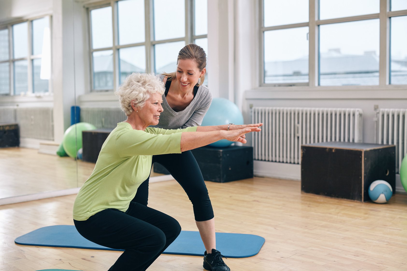 Elderly Woman Doing Exercise with Her Personal Trainer